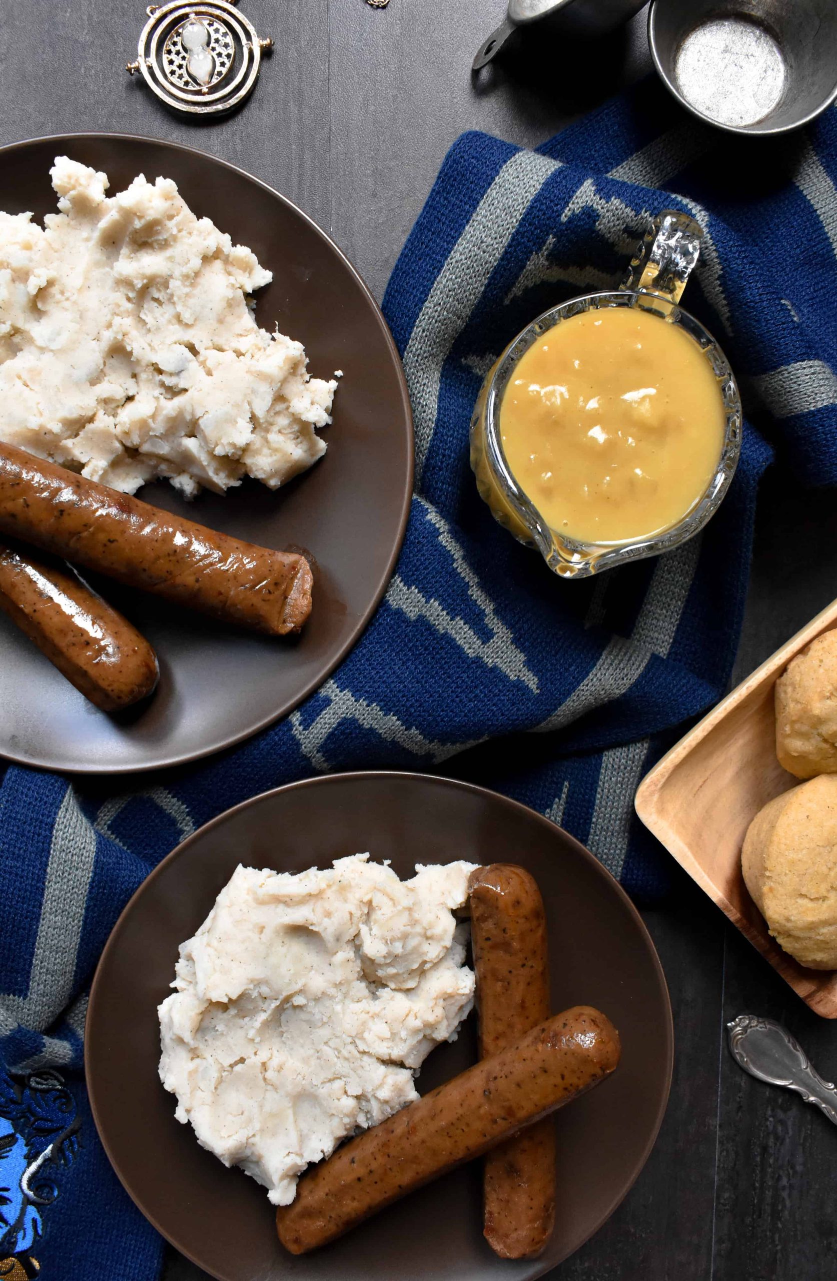 British bangers and mash next to a Ravenclaw scarf from Harry Potter. 
