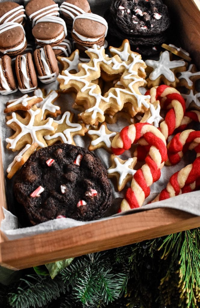 side view of a holiday treat box with four different types of cookies