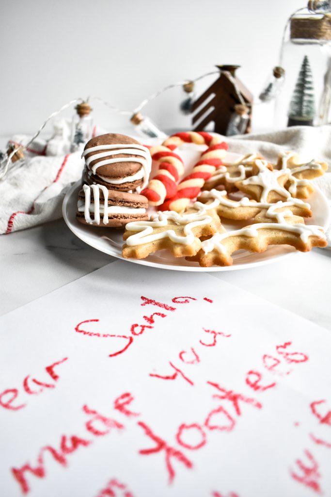 a child's letter for Santa next to a plate of Santa's Christmas cookies