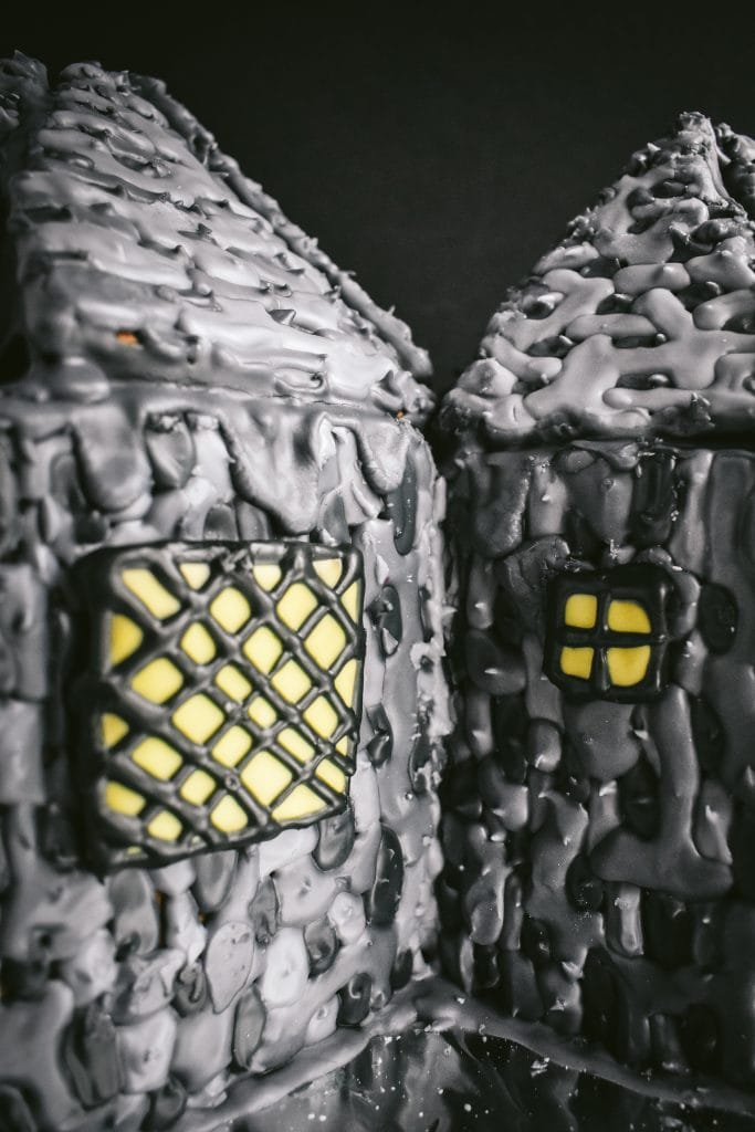 close up of windows on stone walls on a Harry-Potter themed Hagrid's Hut Gingerbread House