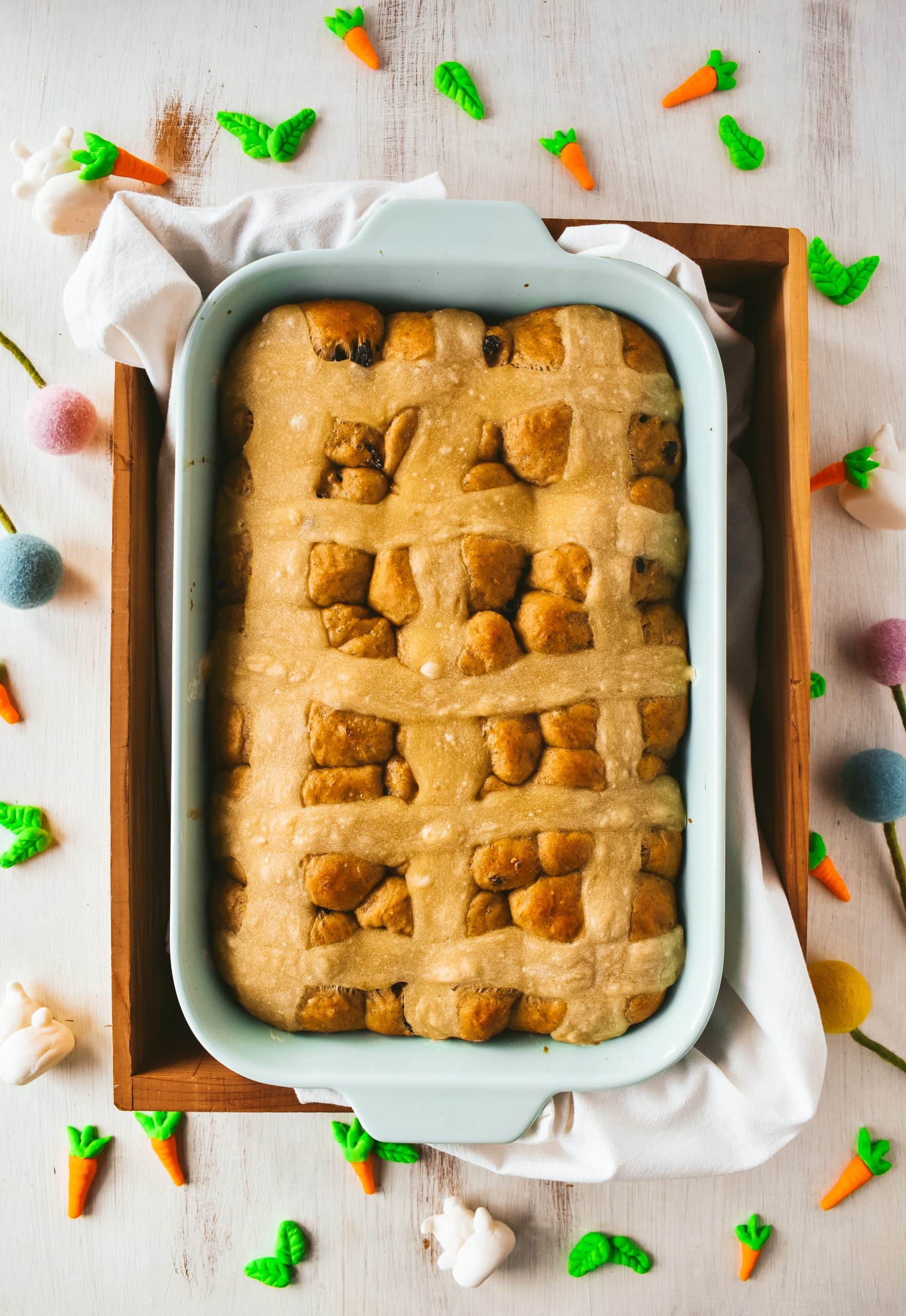 Baked hot cross buns in a 9x13 blue baking dish.