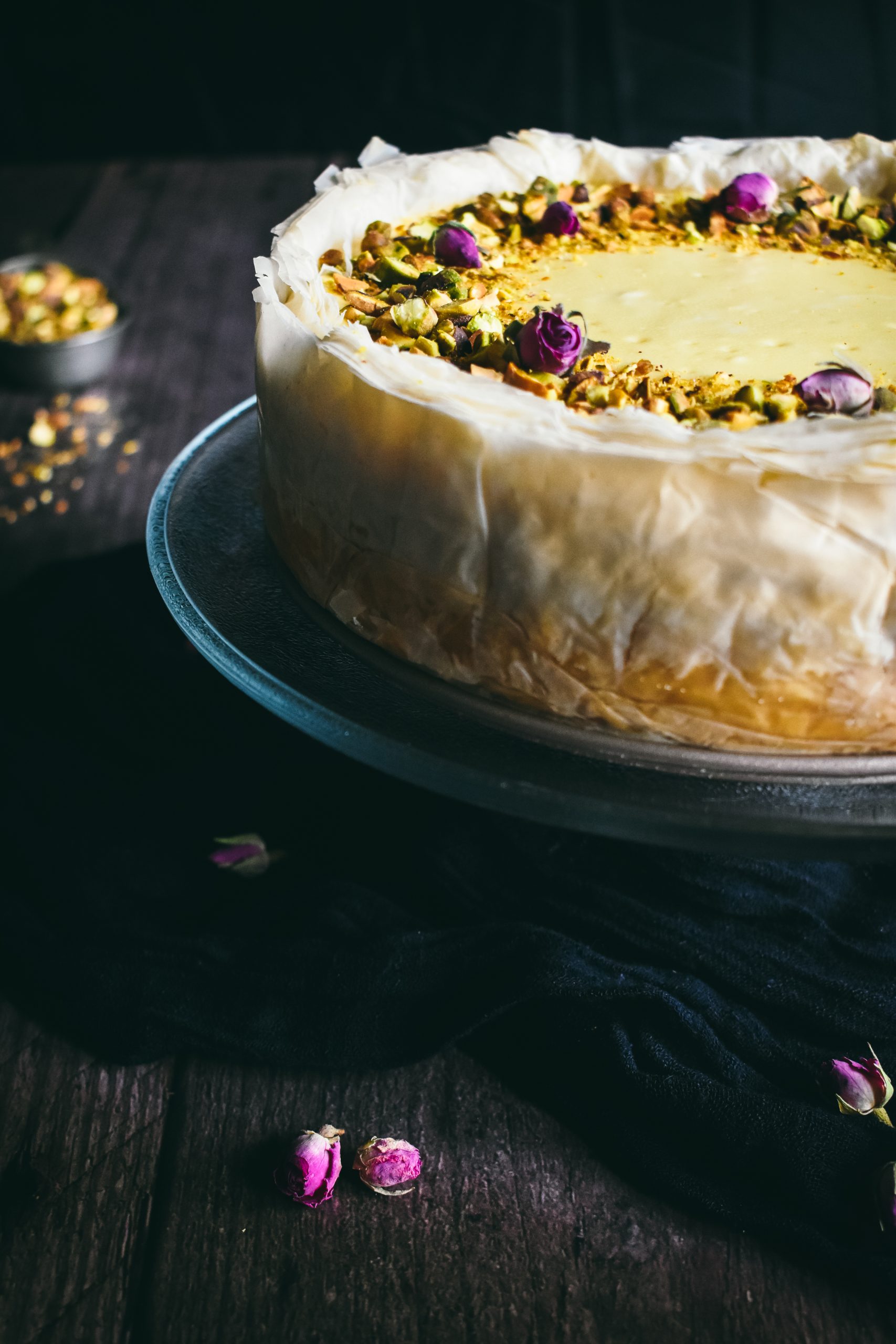 close up of the layers of phyllo dough and crushed pistachio topping on a Middle Eastern dessert