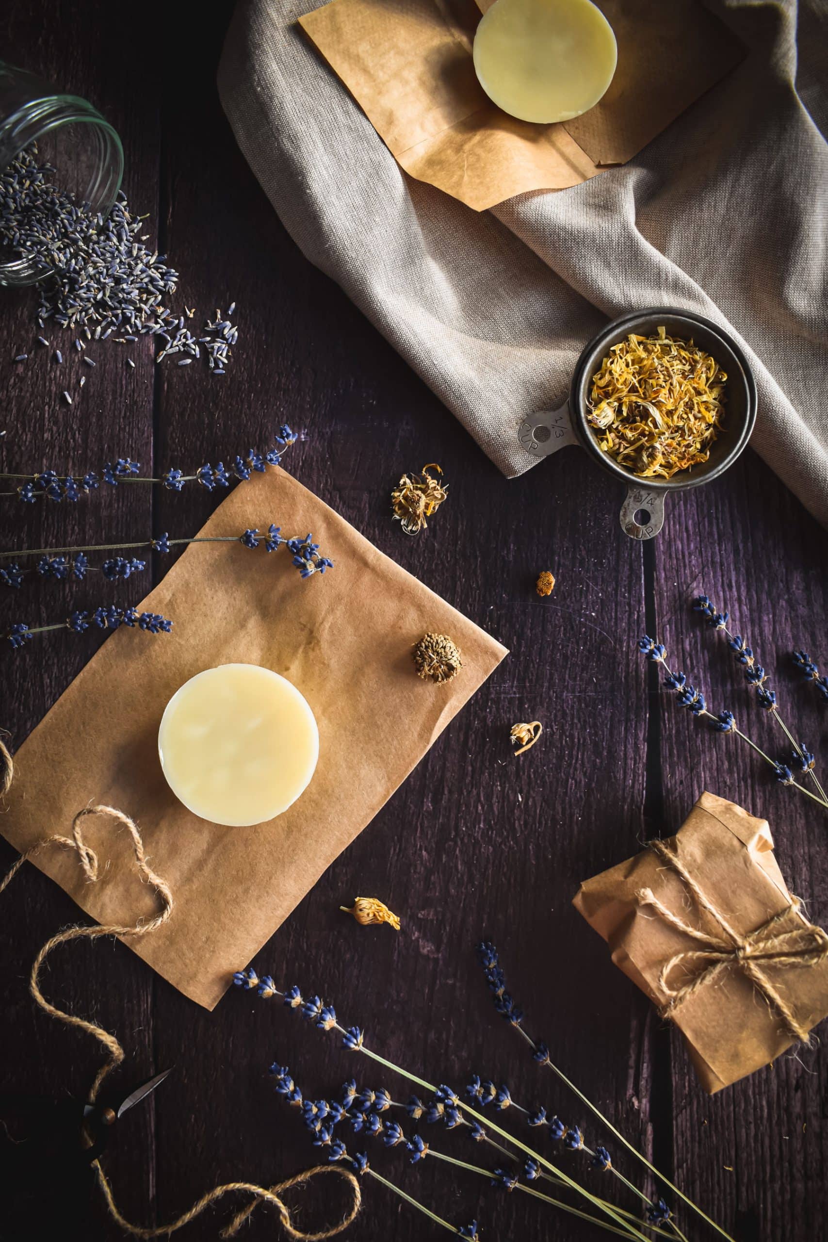 A bar of organic body lotion on a piece of brown paper.