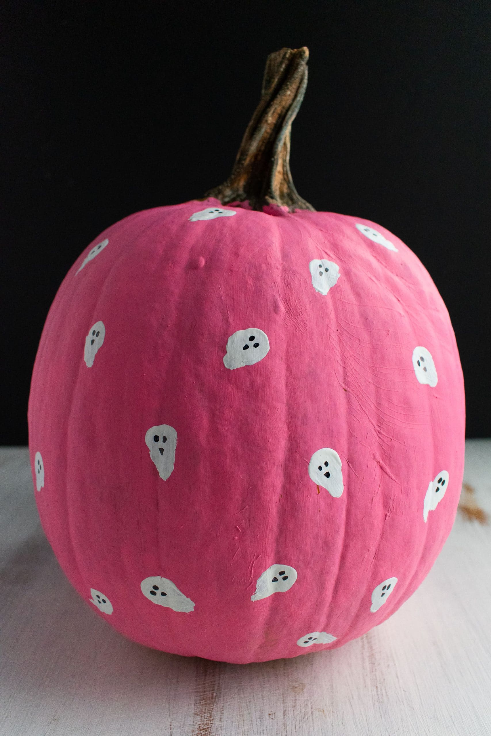 A pink pumpkin with little ghosts for Halloween decoration.
