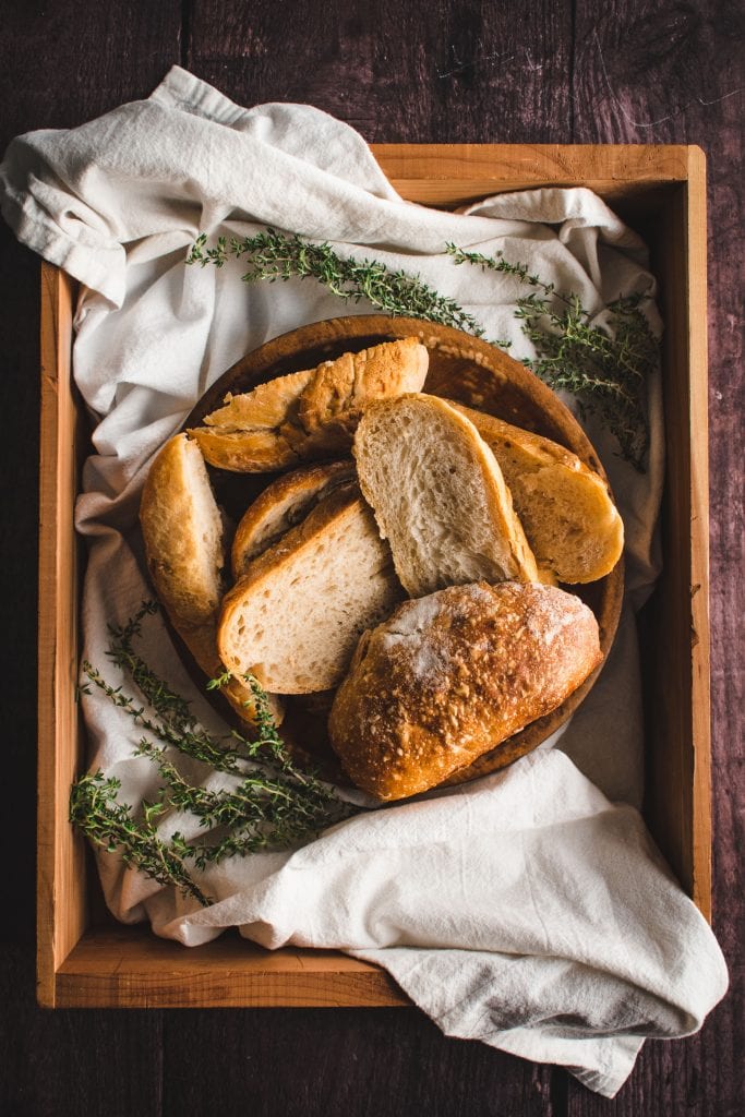 wood crate filled with the ends of bread loaves