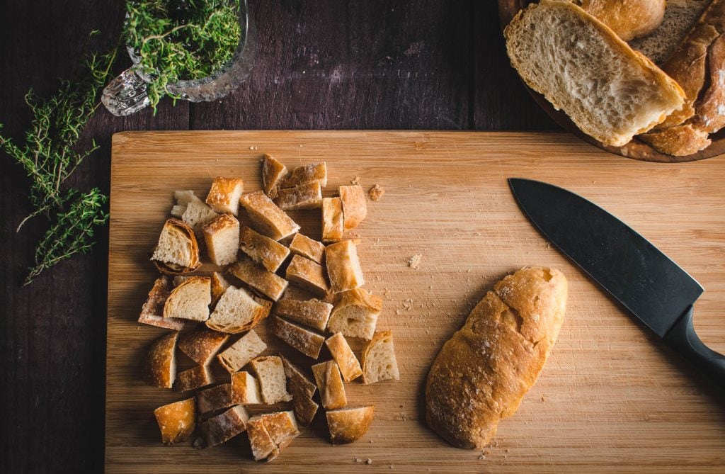diced bread on a wood cutting board