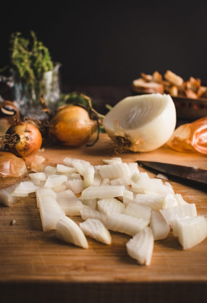 diced onion on a wood cutting board