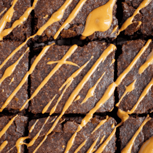 Nine peanut butter brownies drizzled with creamy peanut butter.