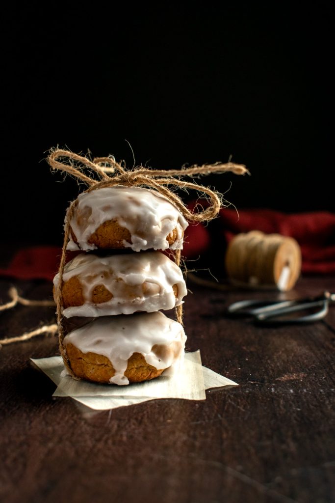 A stack of three glazed cookies tied with twine.