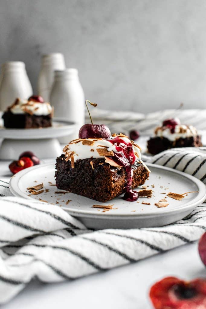 A Black Forest brownies topped with whipped cream and chocolate.