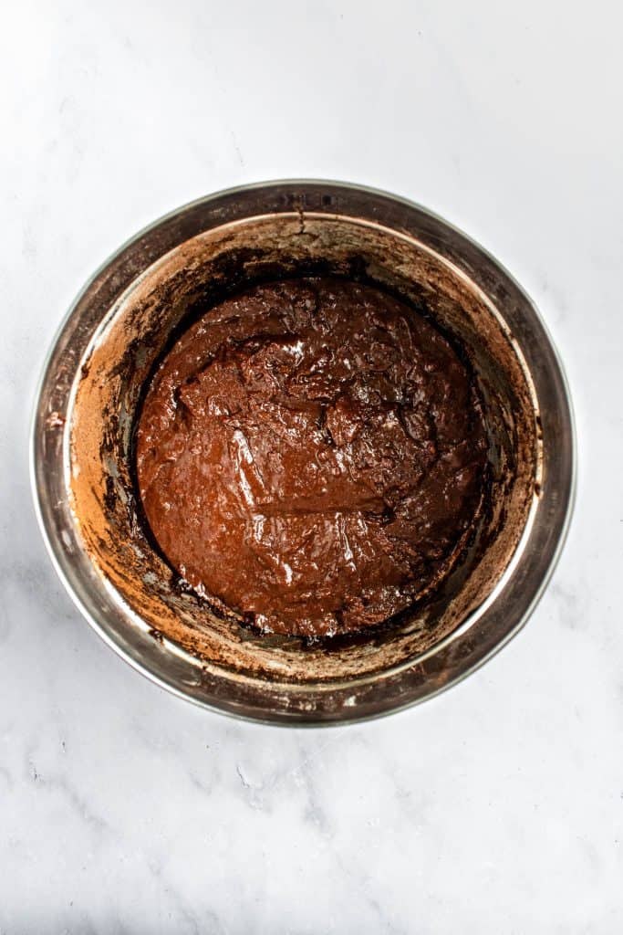 Brownie batter in a metal bowl.