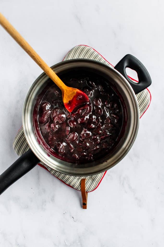 Thicken cherry sauce in a saucepan.