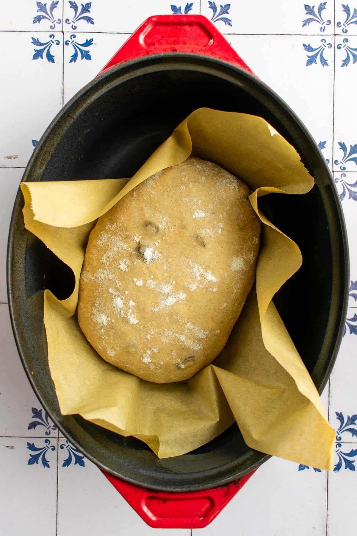An unbaked loaf of bread dough in a Dutch oven.