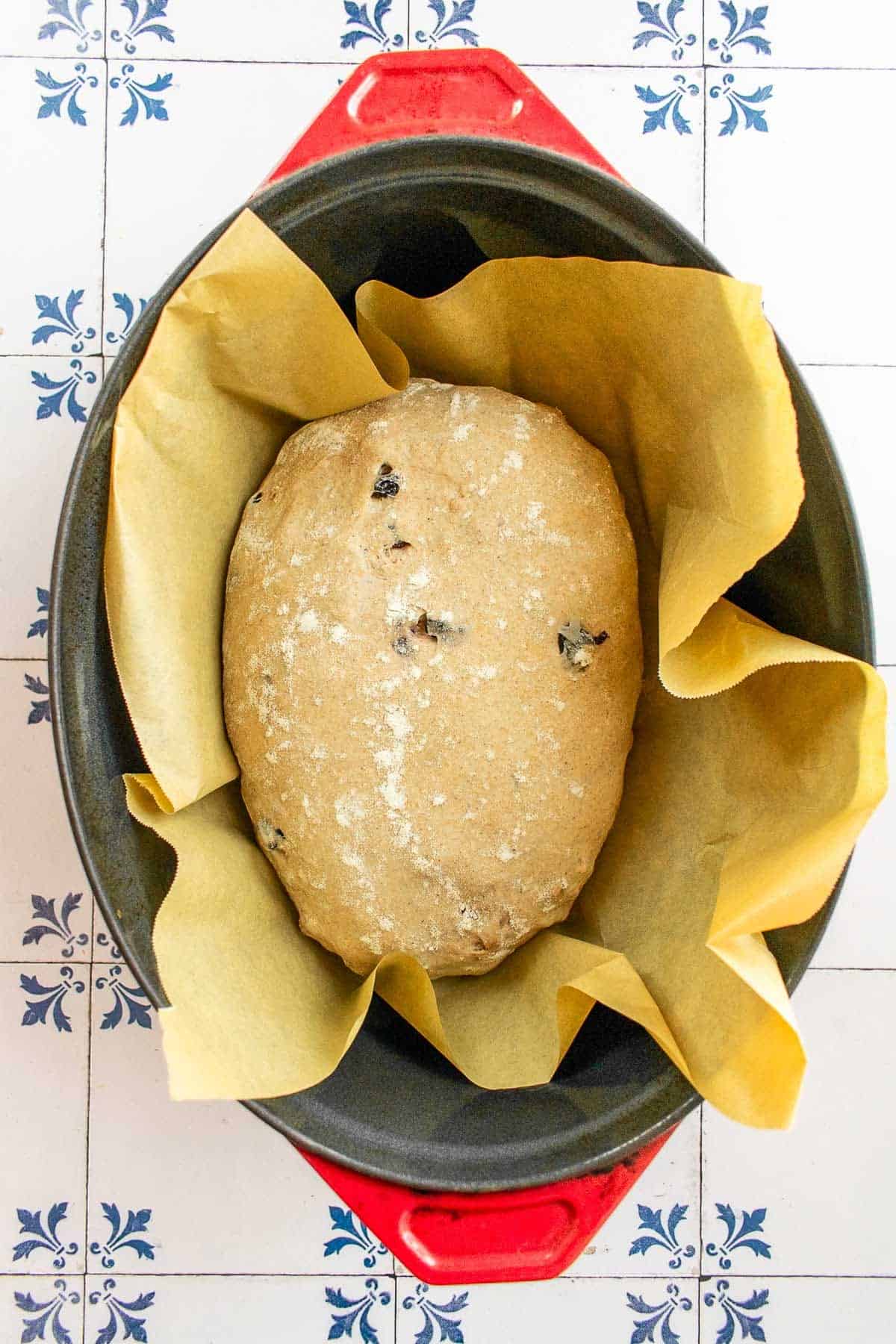 A loaf of unbaked bread in a large Dutch oven. 