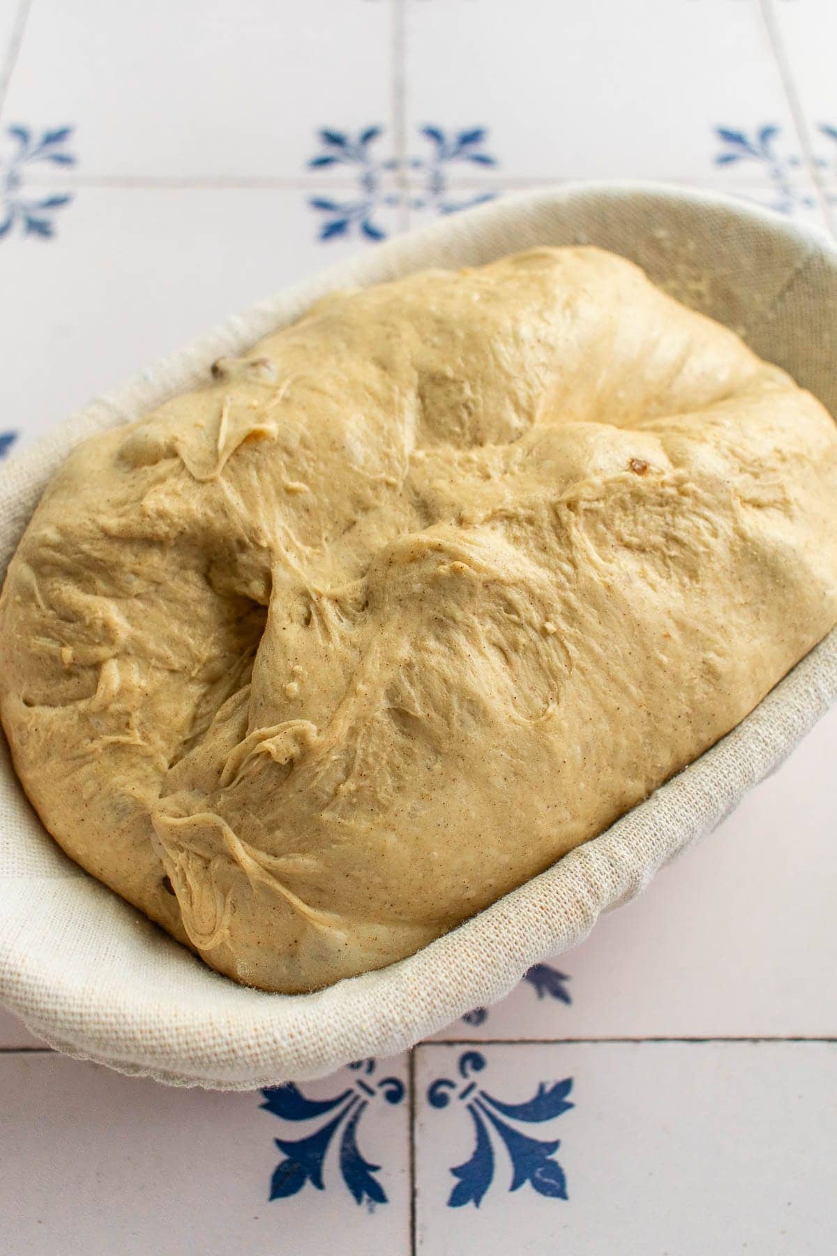 Bread dough in an oval proofing basket.