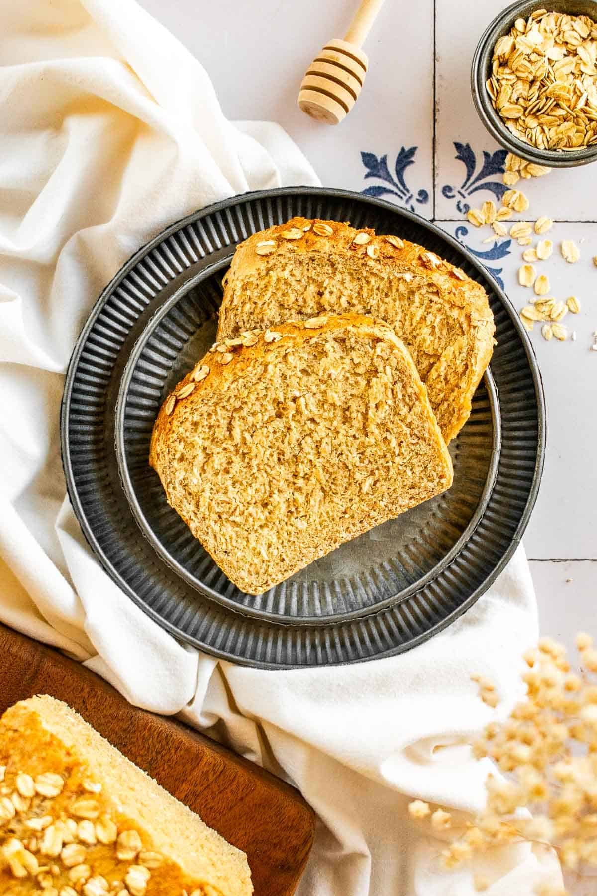 Two slices of light brown bread on a metal plate.