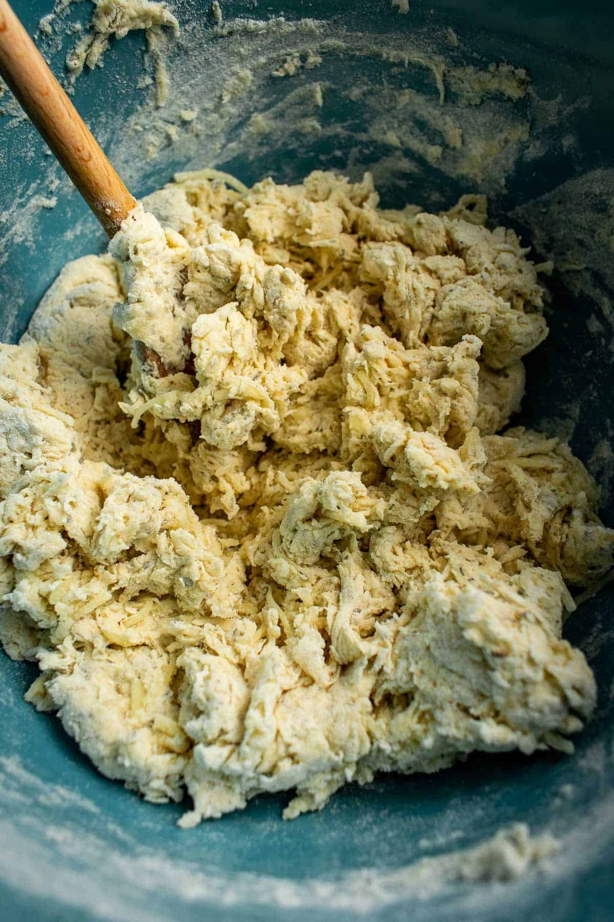 A shaggy bread dough in a mixing bowl.