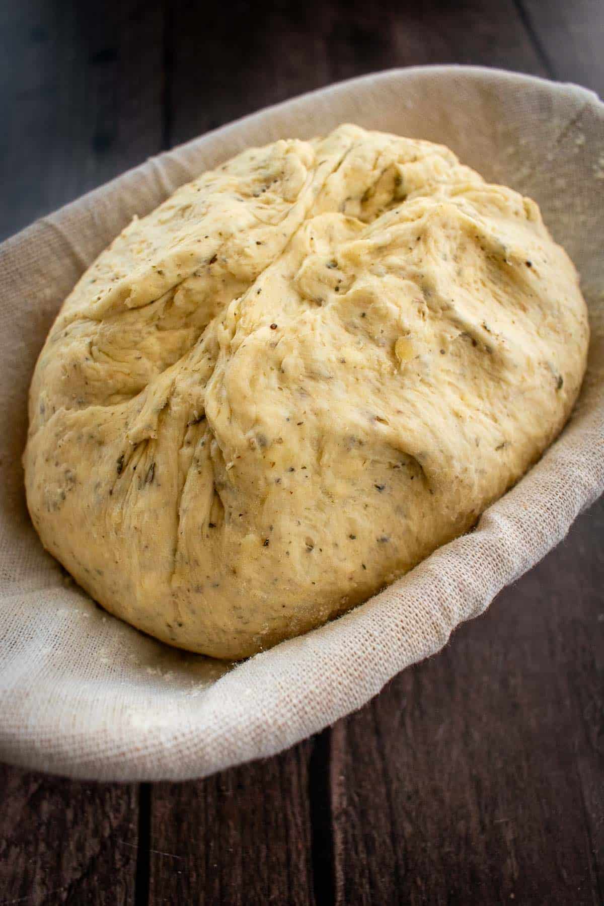 Unbaked bread dough in a proofing basket.