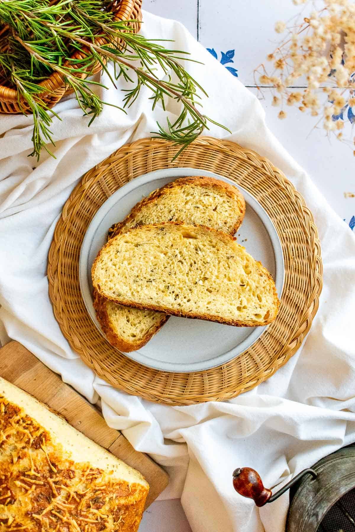Two slices of artisan bread on a grey plate.