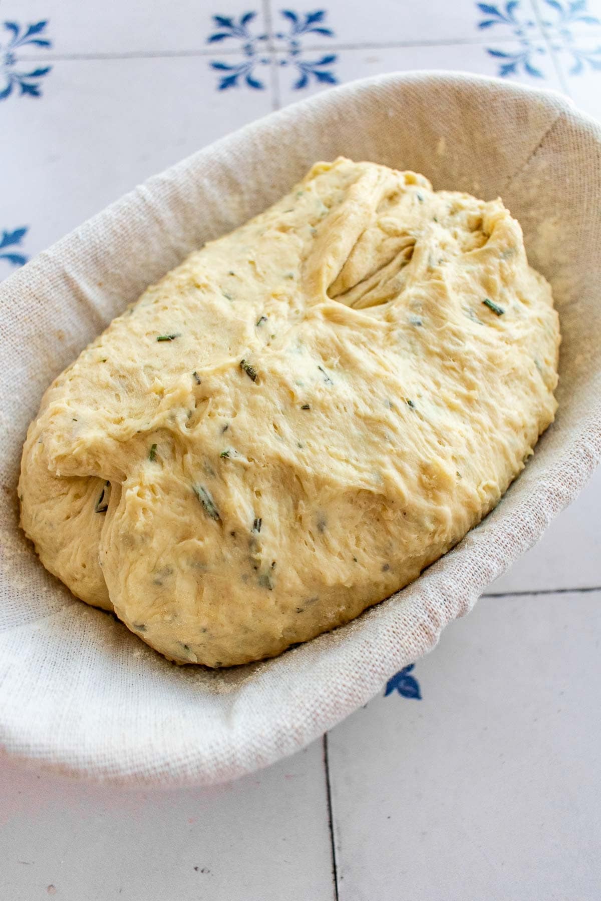 Unbaked bread dough in a proofing basket.