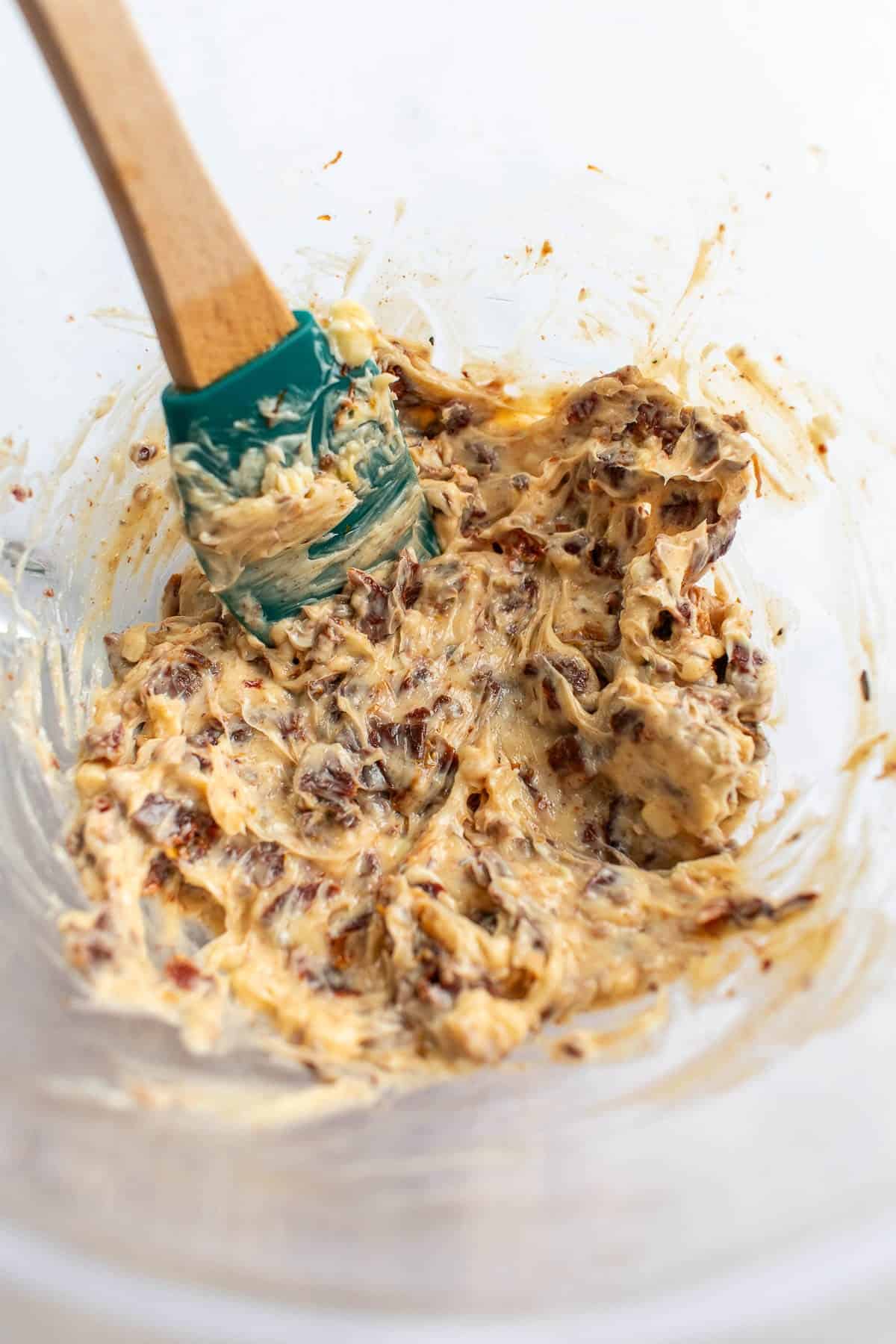 Creamy tomato compound butter in a glass bowl.