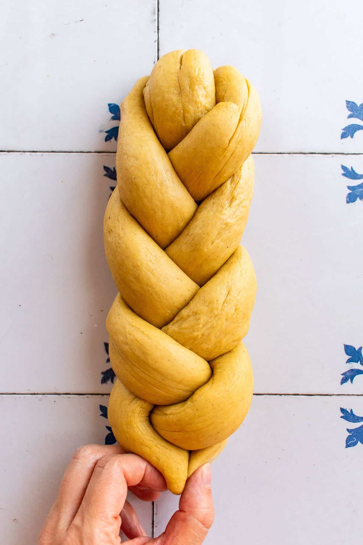 A braided loaf of dough on a table.