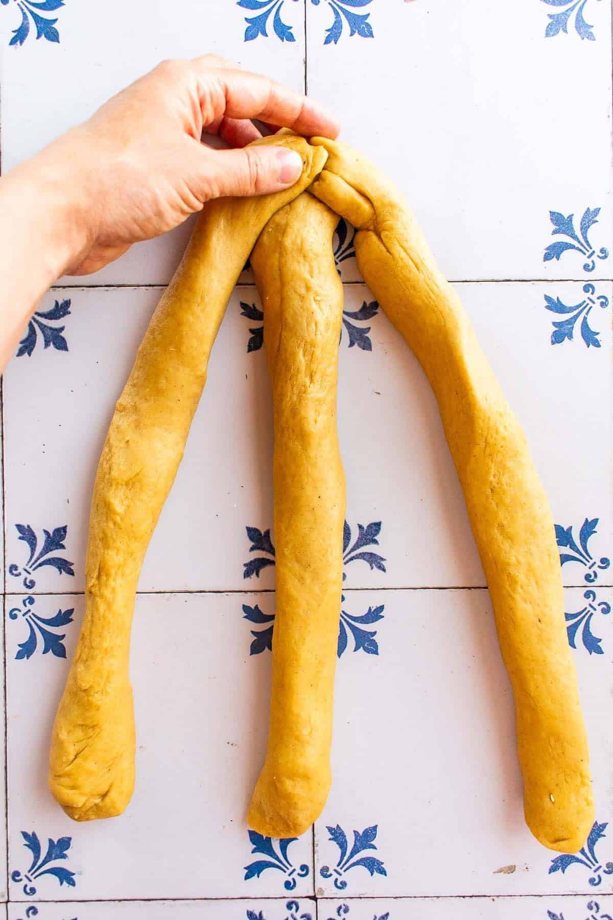Three stands of dough connect at the top.