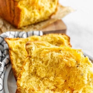 Two slices of fluffy cheese bread on a plate.