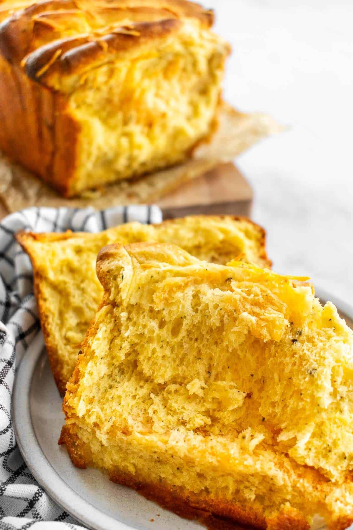 Two slices of fluffy cheese bread on a plate.