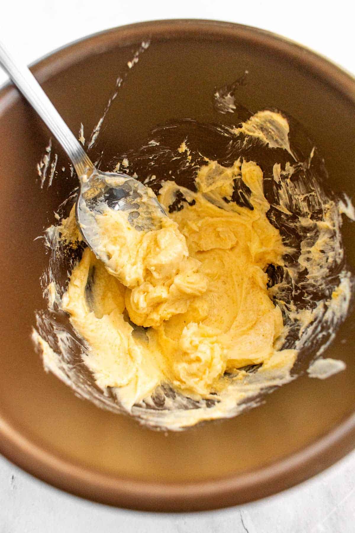 A small bowl filled with creamy garlic butter.