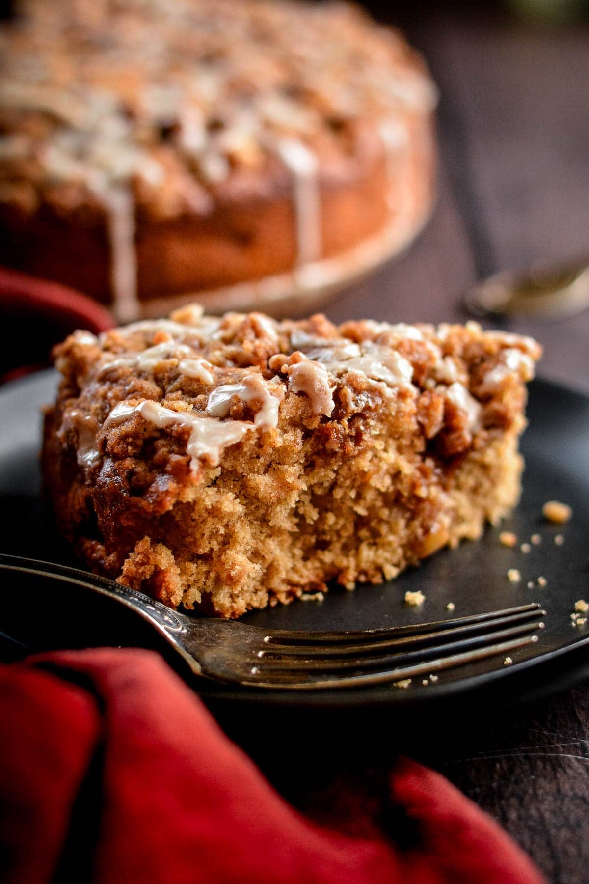 A slice of apple crumb cake on a plate.