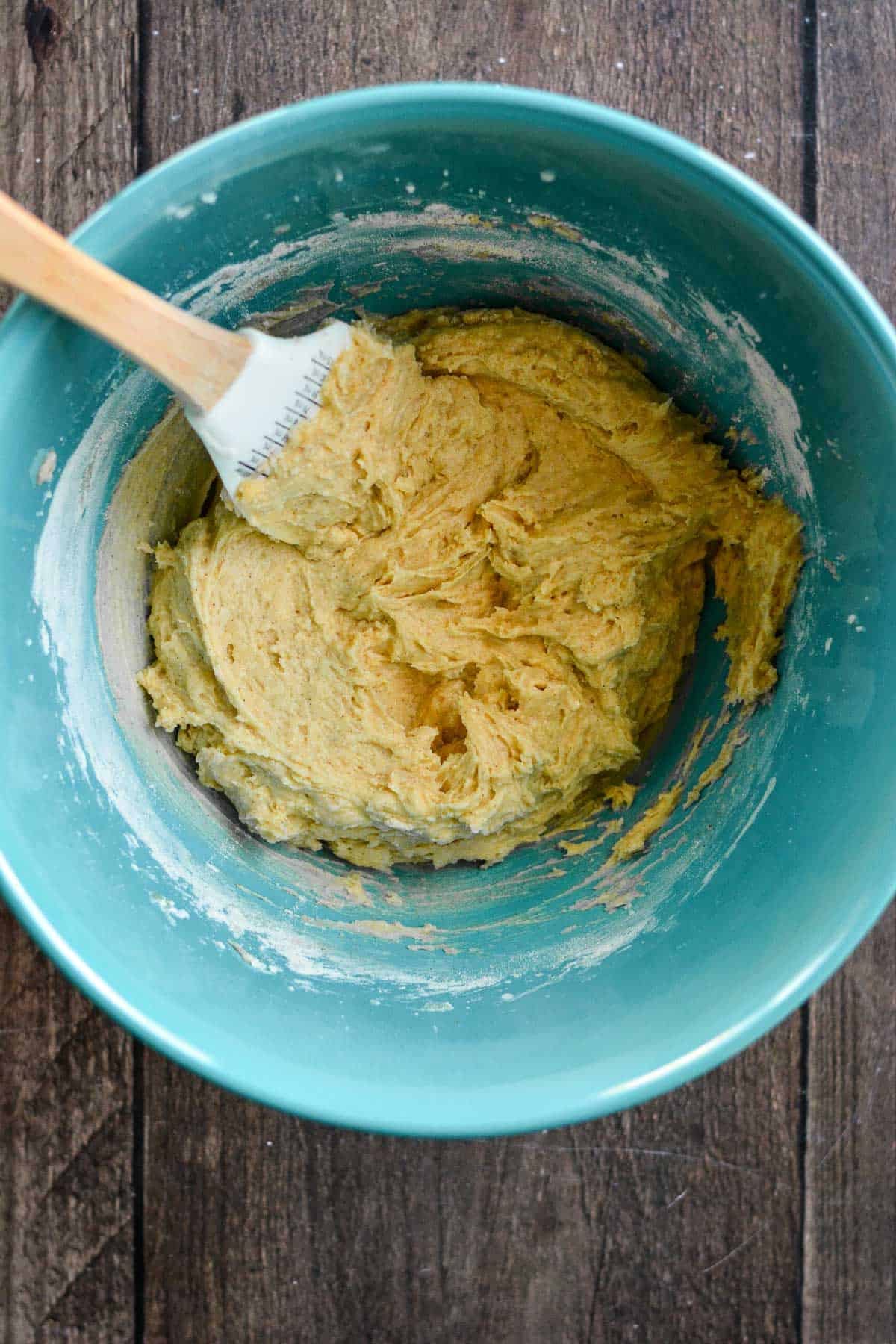 Light cake batter mixed in a large blue bowl.