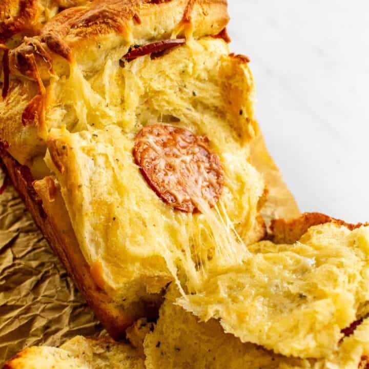 A cheesy bread with pepperoni in the center.
