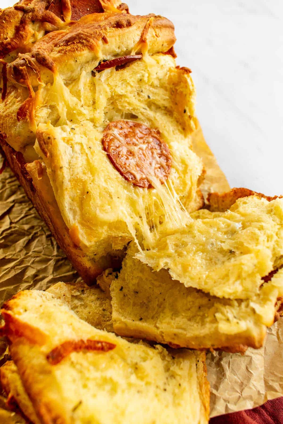 Melted cheese and pepperoni in between slices of baked bread.