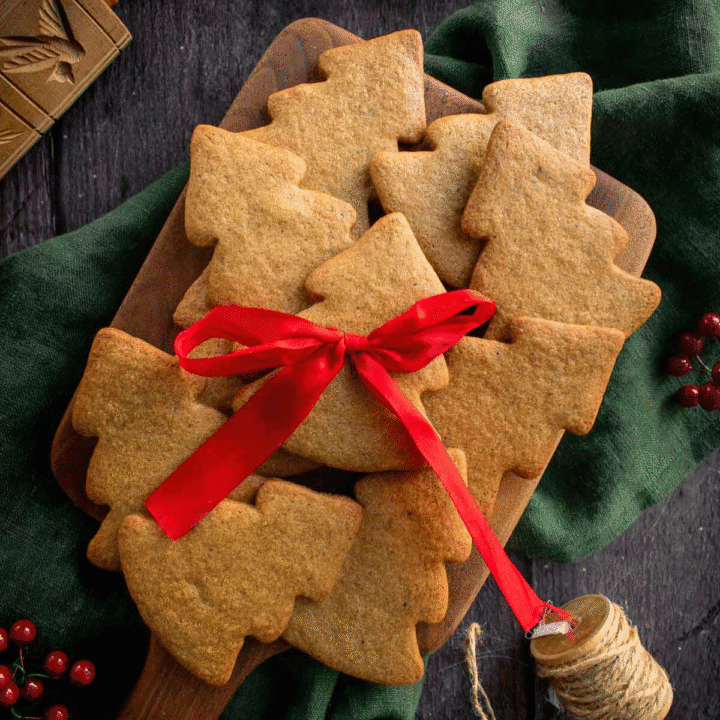 A pile of brown tree-shaped cookies under a red ribbon.