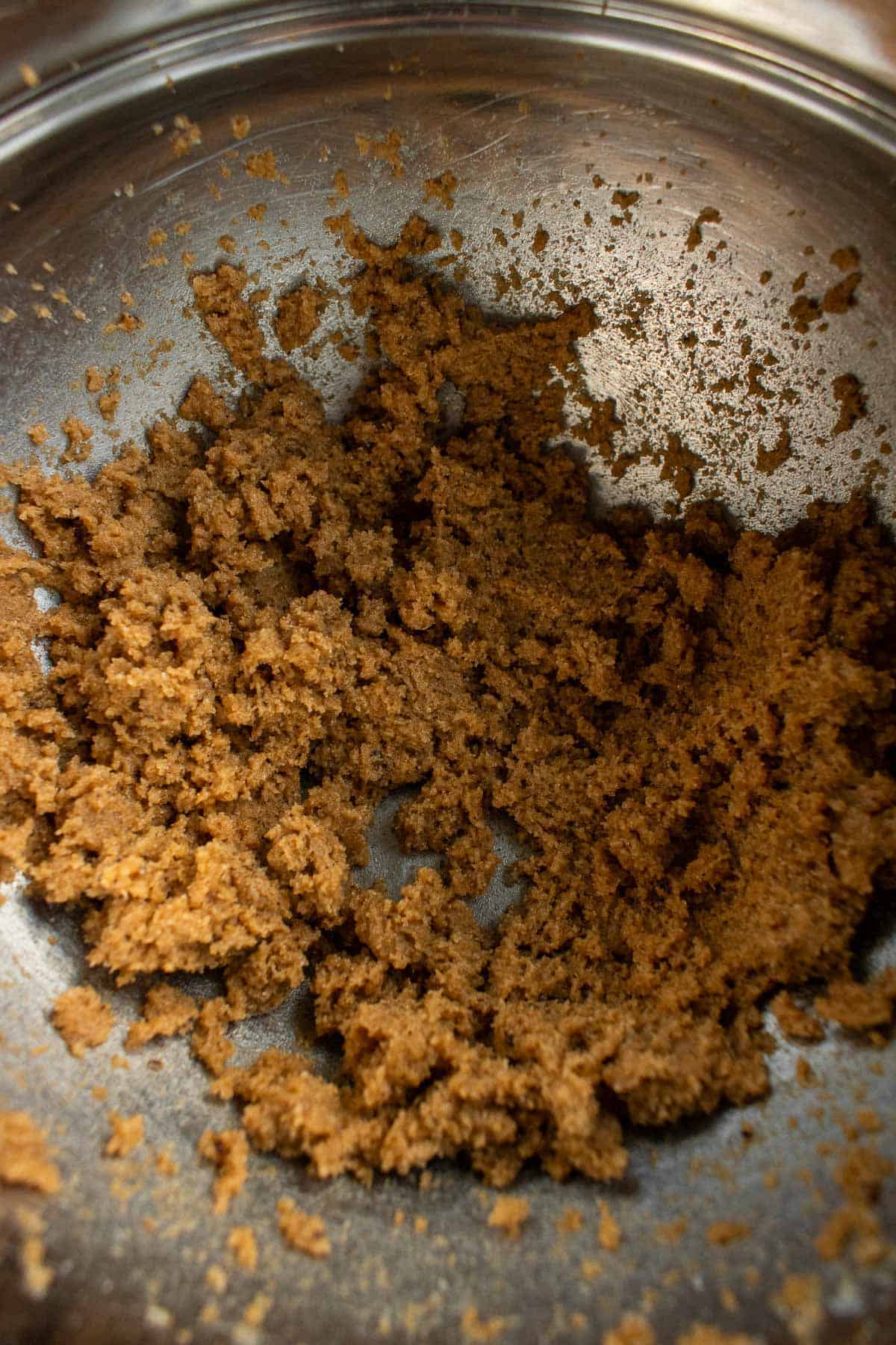 Beaten butter and sugar in a metal mixing bowl.