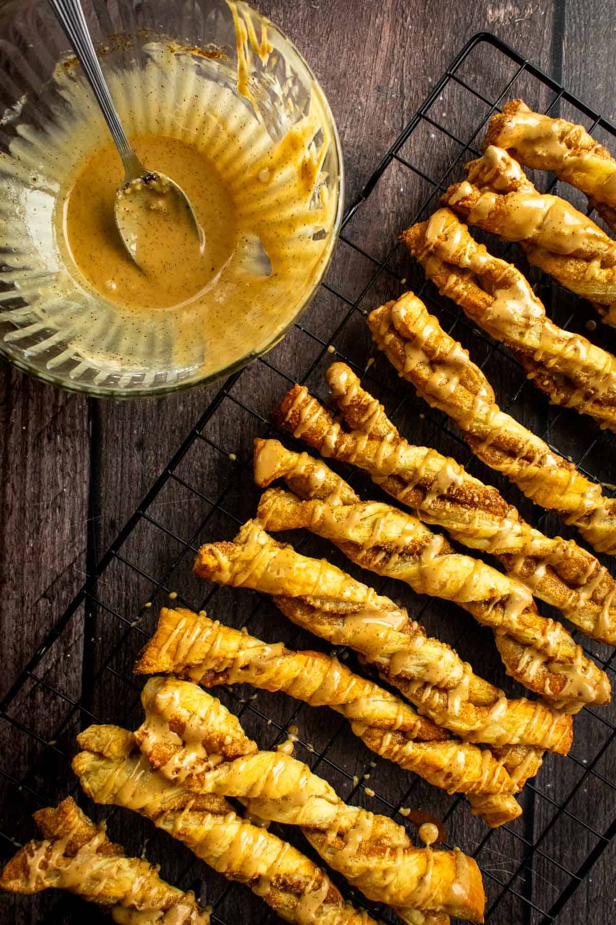 Baked puff pastry twists drizzled with a light brown icing.