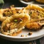 Three pear blue cheese tarts on a small plate.