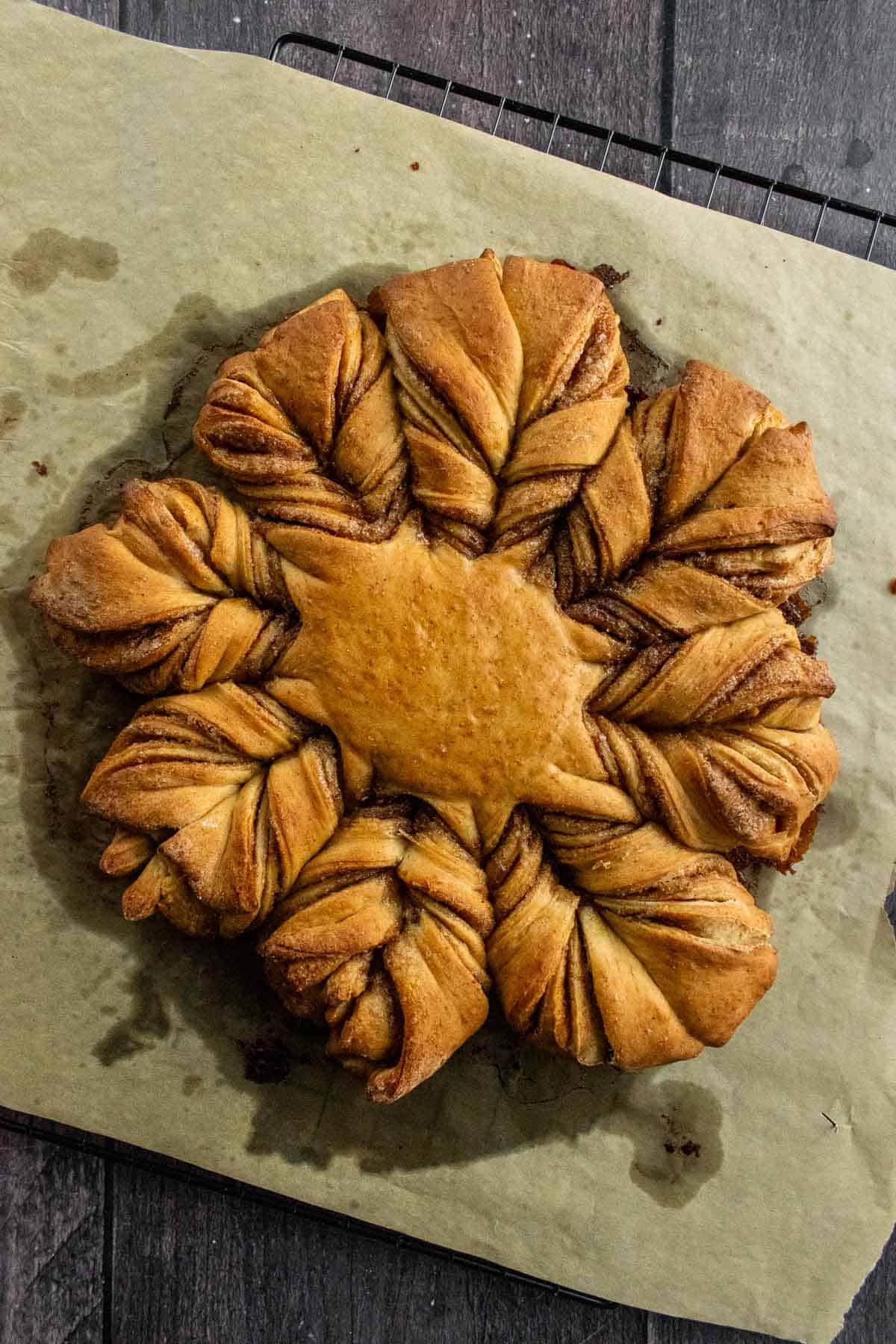 Baked star bread on parchment paper.