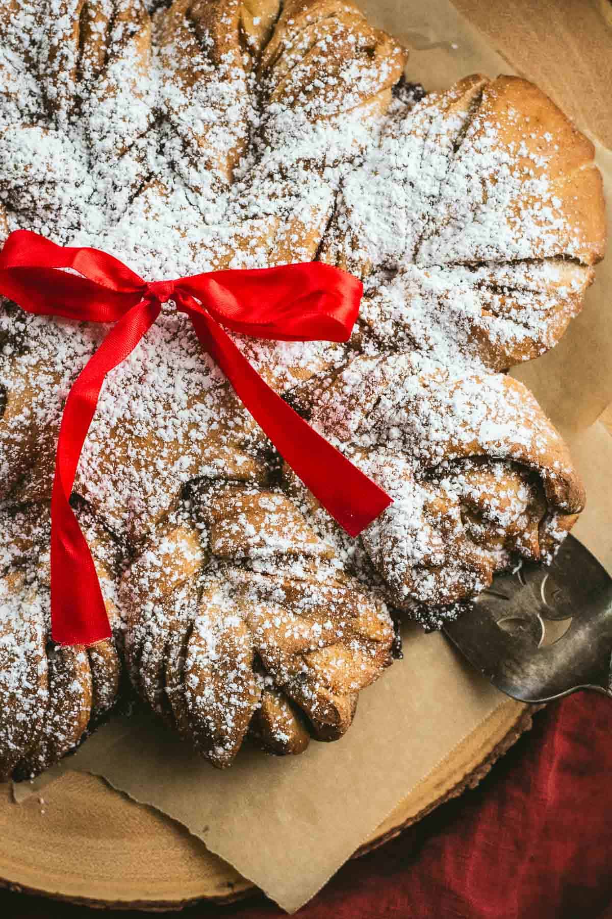 Twisted bread filling with cinnamon and sugar on a wood board.
