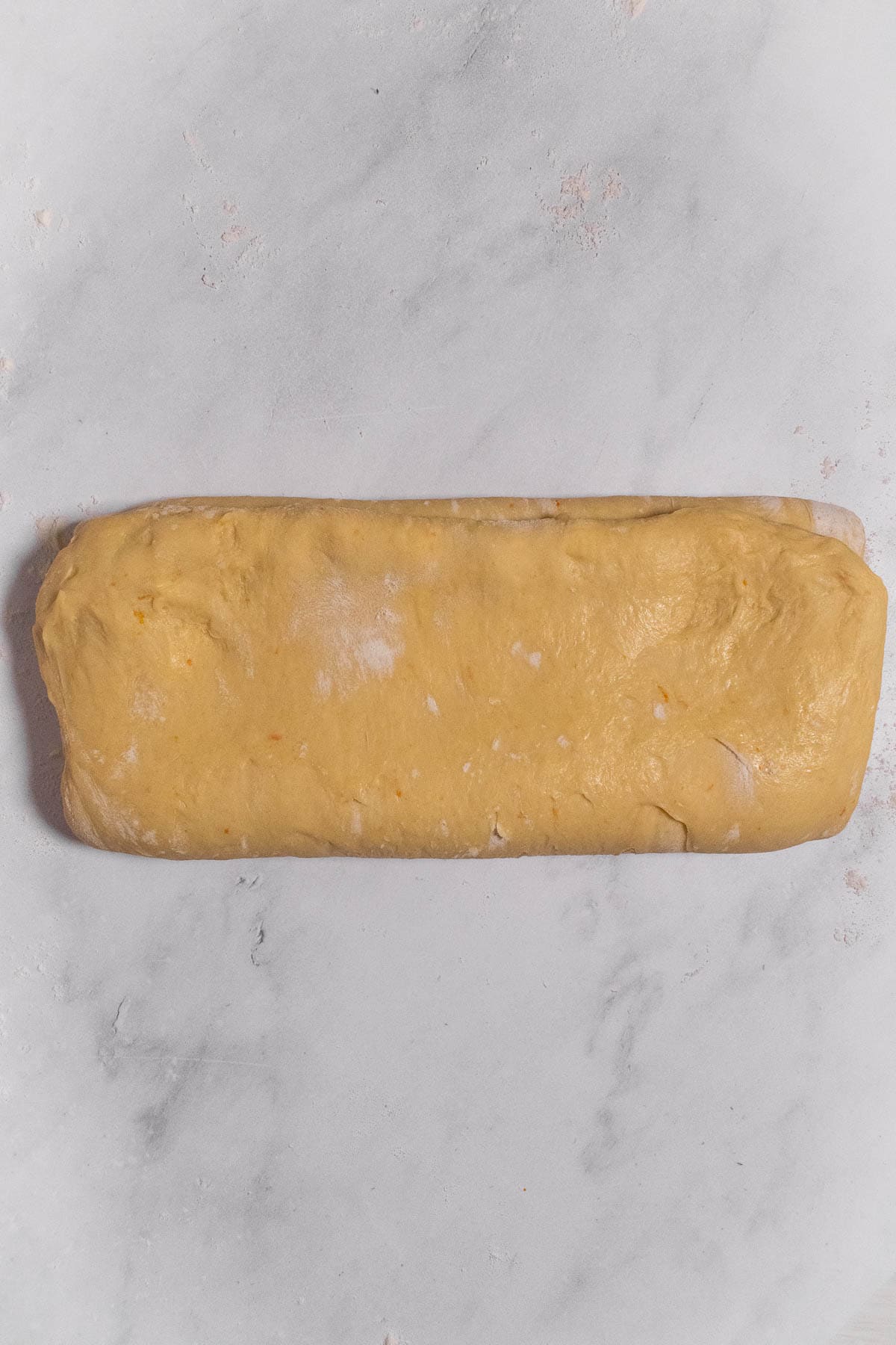 Soft bread dough folded into thirds like a letter.