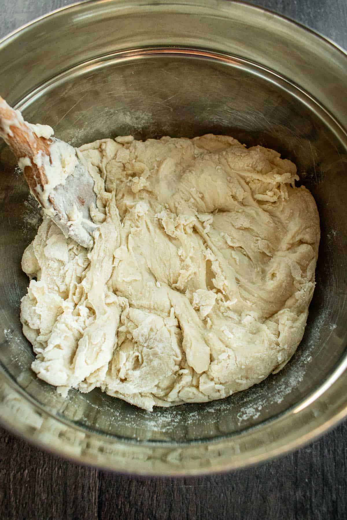 Flour and water mixed in a bowl to form a shaggy dough.