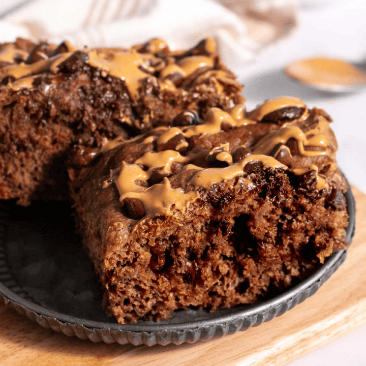 Two large pieces of dark brown focaccia made with chocolate and peanut butter on a metal plate.