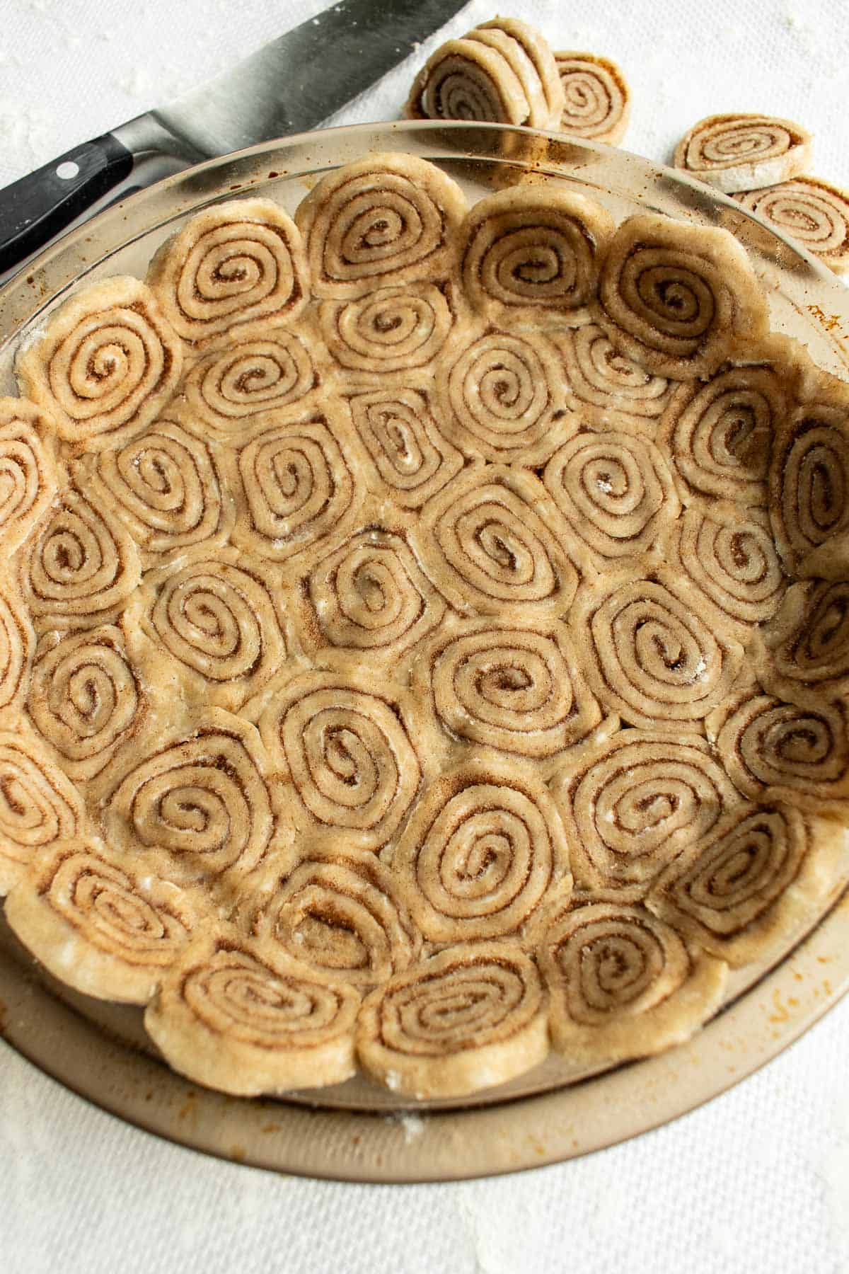 Mini cinnamon rolls made from pie crust pressed into a pie dish.