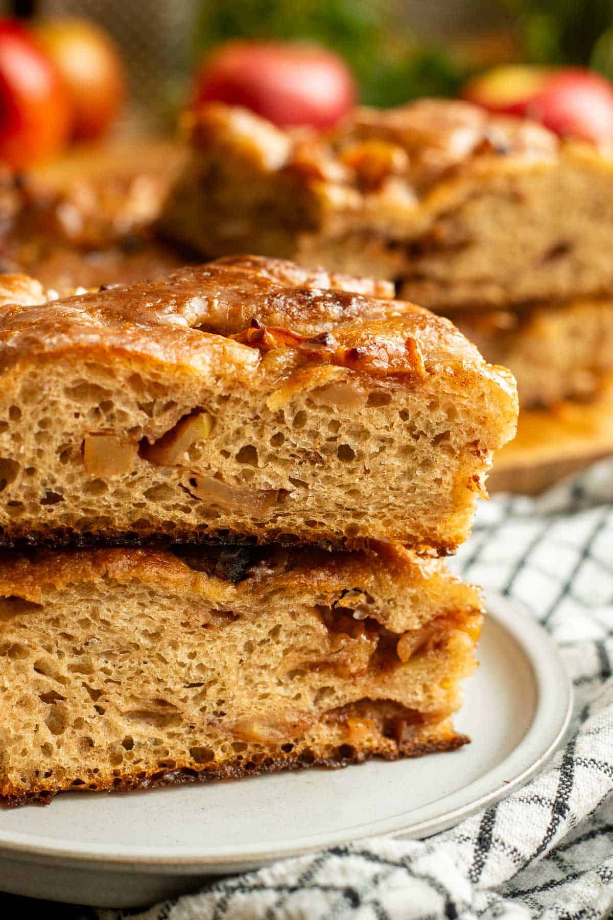 Two large pieces of fluffy focaccia stacked on top of eachother and filled with diced apples.