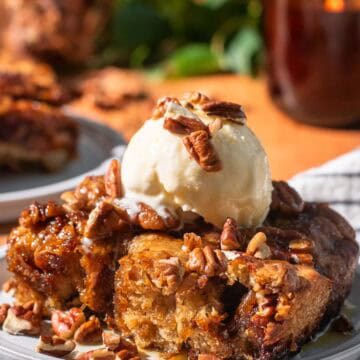 A large square of focaccia topped with candied pecans and a scoop of ice cream.